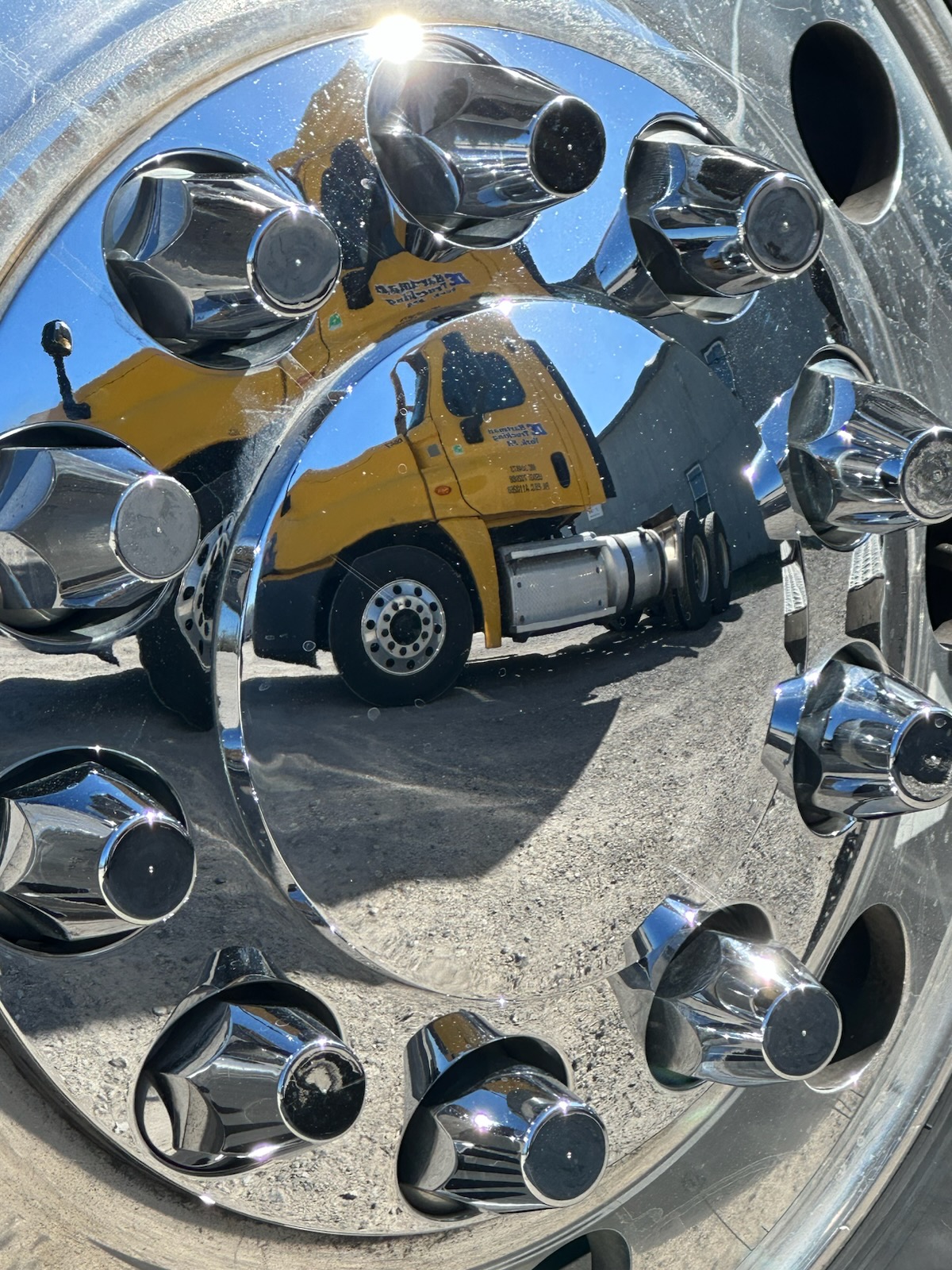 DE Hartman truck reflected in polished wheel hubs